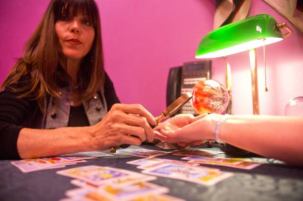 Michelle, who specializes in tarot card and palm reading, uses ...